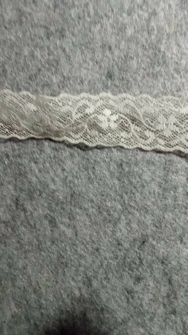 Cream colored flat lace, scalloped edges