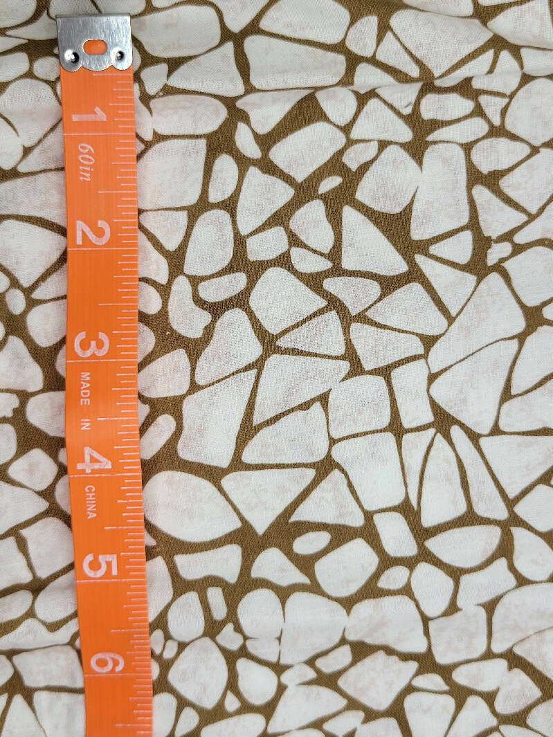 White pebbles on tan background 12" x wof