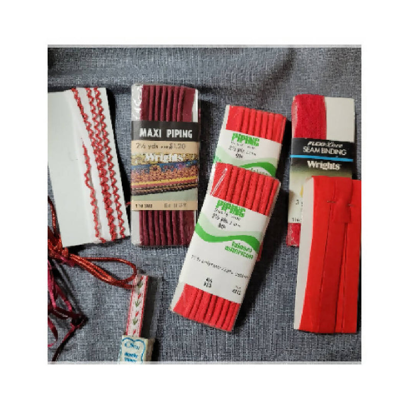 Bundle of red sewing trims and laces